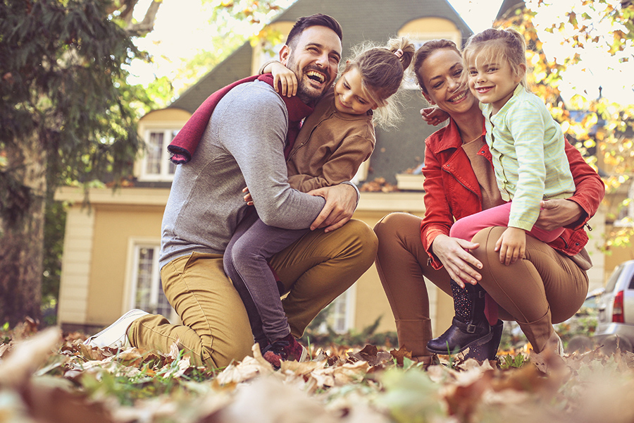 Personal-Insurance-Family-Having-Fun-Outside-Their-Home-While-Playing-in-Leaves-in-the-Fall